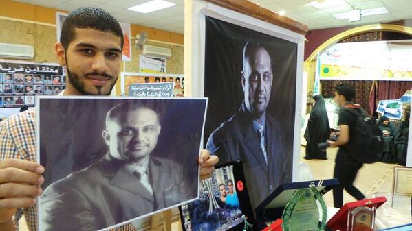 Jaffar holding photo of his imprisoned father