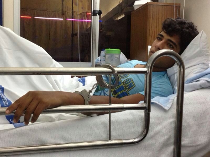 Ali AlQassab handcuffed to the hospital bed